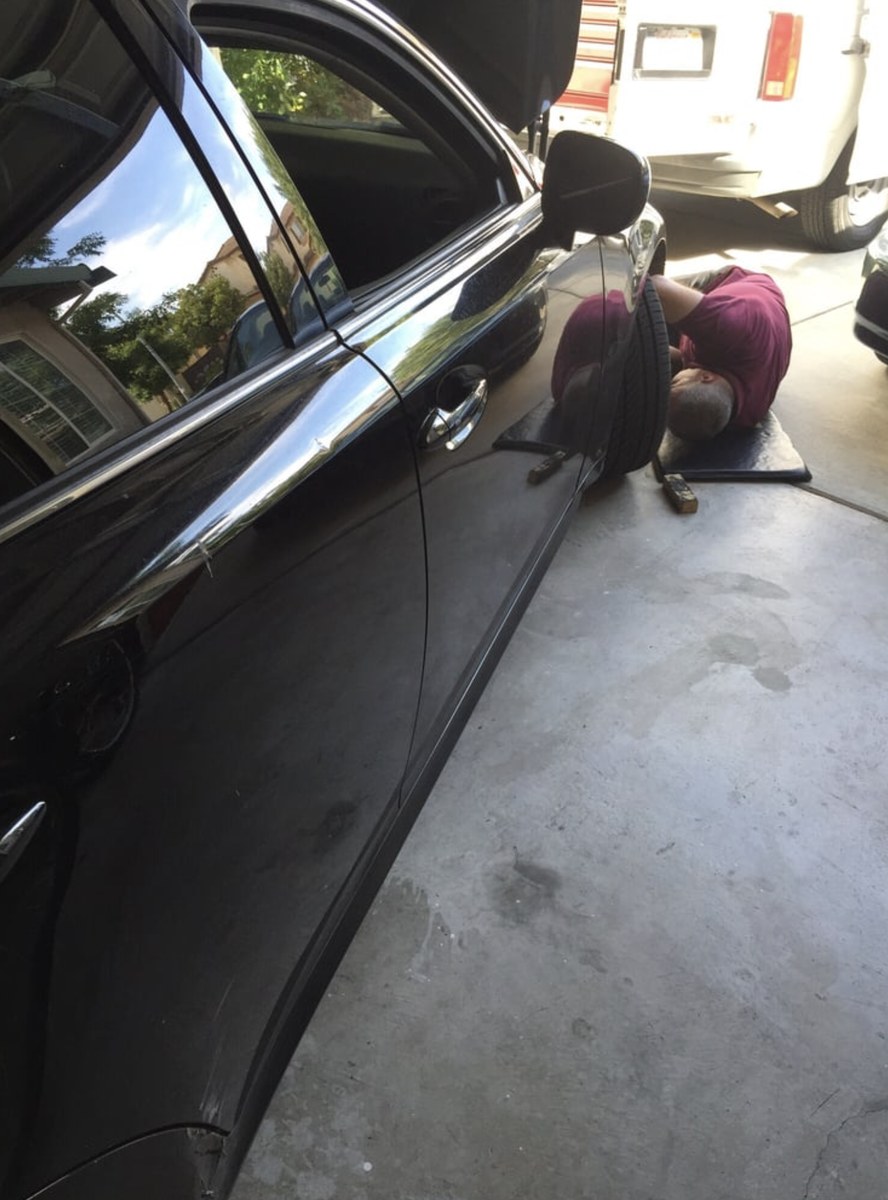 Everett mobile mechanic working under a car at a customer's home
